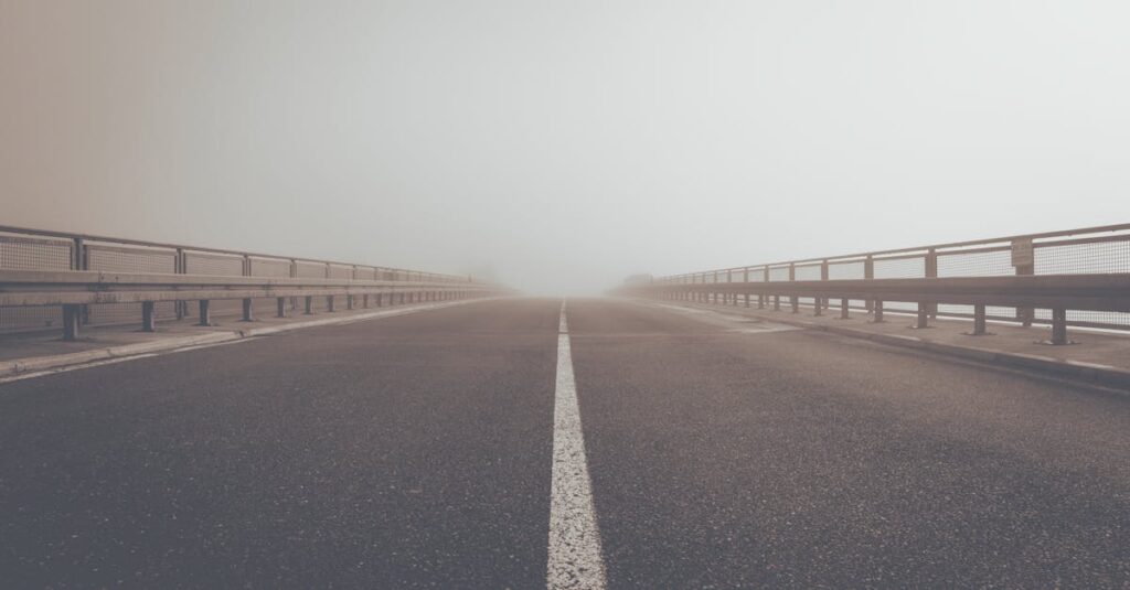 A misty road creating an atmospheric perspective and moody ambiance.